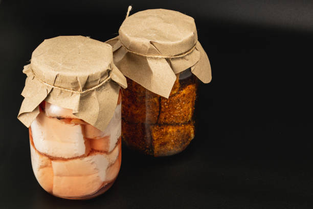 Homemade canned food featuring boiled lard and pickled beans in jars