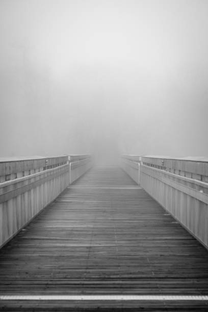 istock A boardwalk disappears into the fog 2193352105