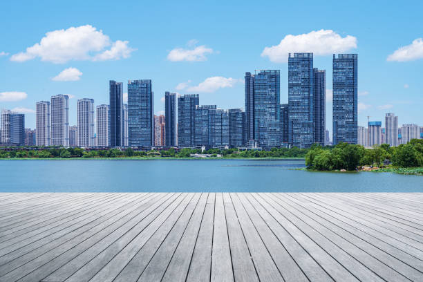 istock Empty wooden viewing platform with modern urban skyline and sunny blue sky background 2193356625