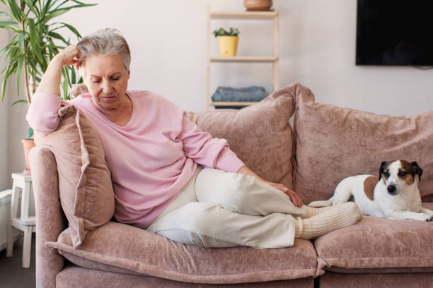 istock middle aged lady looking away sit alone at home feel anxious lonely, sad 2193360320