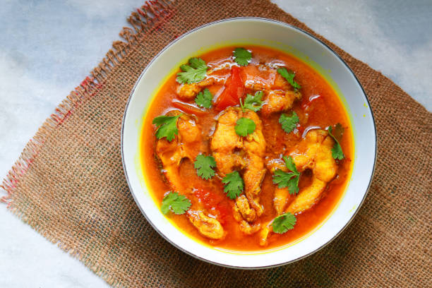 istock Fish curry in a bowl on a white table. Top view, flat lay 2193363827