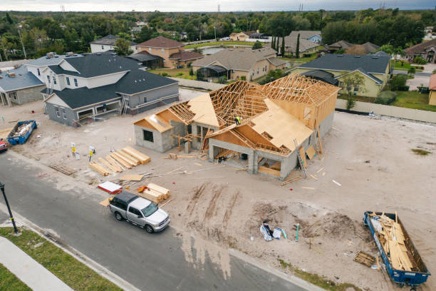istock New Construction Homes - Orlando Florida - Developing Neighborhood - Three Houses Under Construction - Worker Adding Roof - High Angle 2193365734