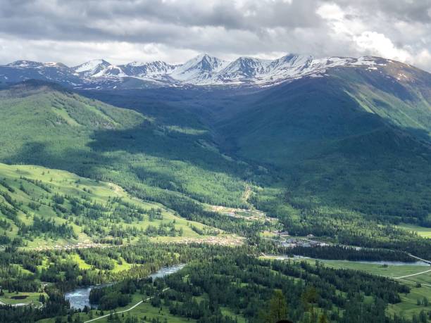 istock Lush Valley with Snow-Capped Mountains 2193366422