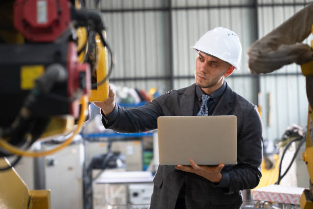 istock Business or engineer Caucasian male use notebook computer checking robot arm 2193368072