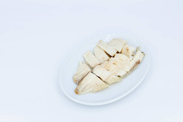 Fish, Steamed fish meat Cooked fish fillet, A neatly arranged plate of cooked fish fillets, sliced and presented on a clean, white plate, Asian food