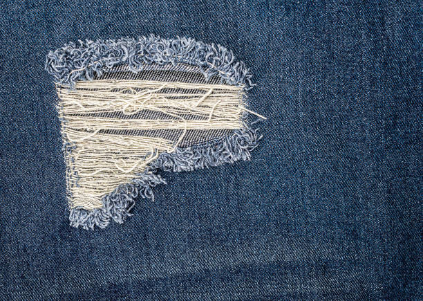 istock Close up texture blue ripped jeans  background 2193369214