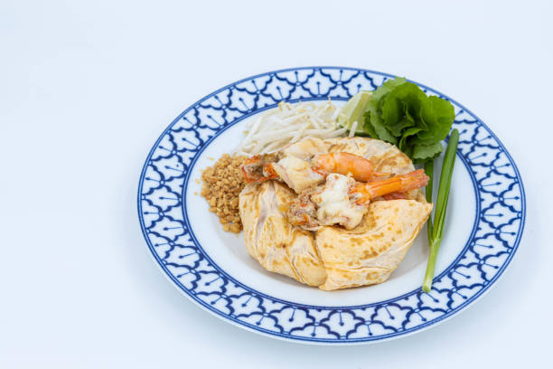 Prawn Pad Thai, Fried noodle Thai style with prawns, Fried Thai Noodle with Shrimp Wrapped in Egg on white background, Thaifood
