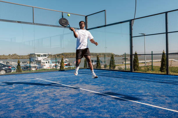 istock Padel player jumping and hitting the ball during a match 2193369245