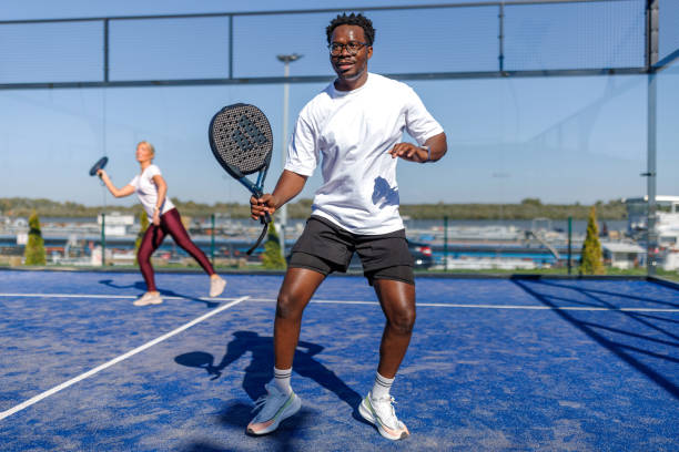 istock Man playing padel on a sunny day with a woman 2193369263