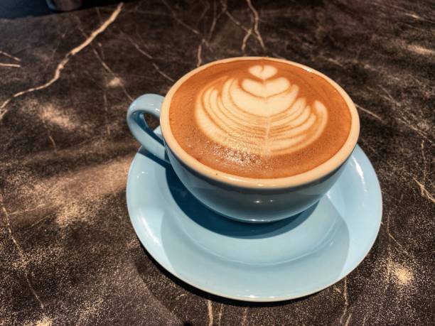 istock A cup of hot chocolate drink with a leaf design 2193370761