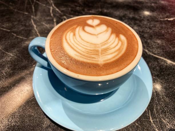 istock A cup of hot chocolate drink with a leaf design 2193370763
