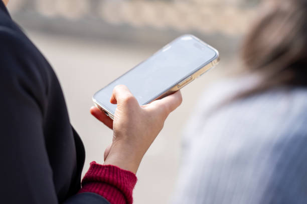 istock Unrecognizable person using a smartphone outdoors in the city 2193370888
