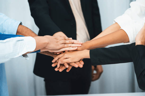 istock Group of diverse office worker join hand together in office. Prudent 2193372887