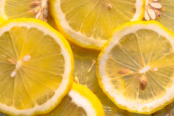 istock Closeup of sliced lemon textured background 2193373484