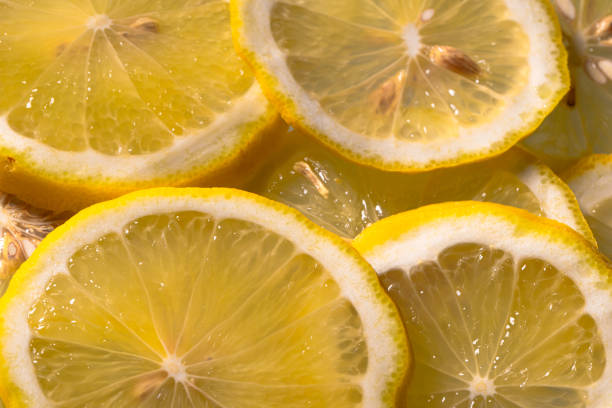 istock Closeup of sliced lemon textured background 2193373487