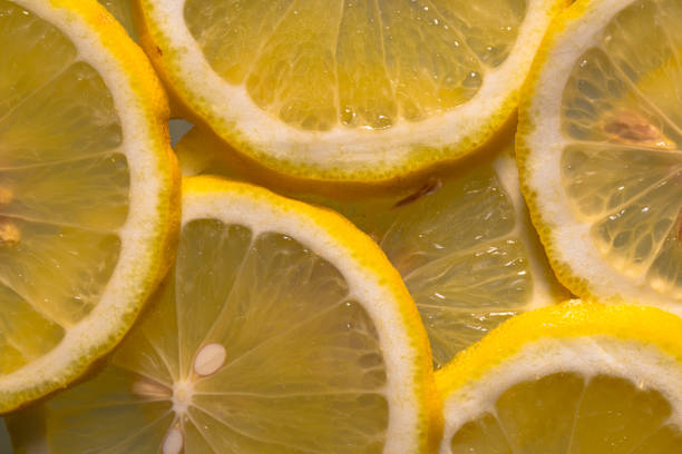 istock Closeup of sliced lemon textured background 2193373512
