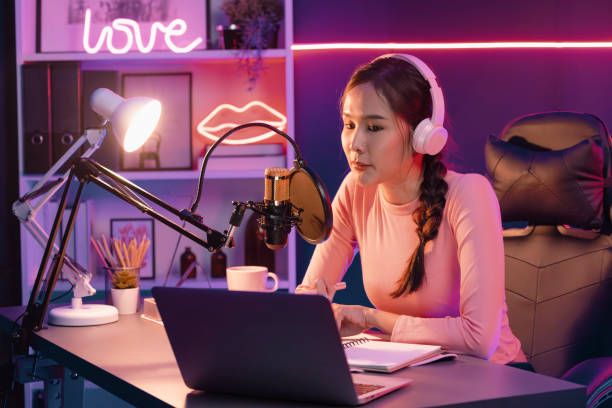 istock Smiling creative young beautiful Asian influencer talking in channel. Stratagem. 2193373619