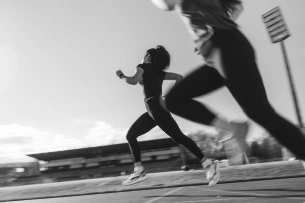 istock Two young multiracial female athletes running on stadium track 2193375400