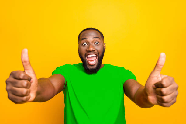 istock Photo of rejoicing ecstatic excited cheerful smiling man enjoying his purchase while isolated with yellow background 2193376693