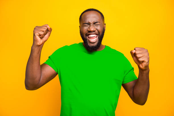 istock Photo of bearded overjoyed ecstatic man having won some competitions while isolated with yellow background 2193376696