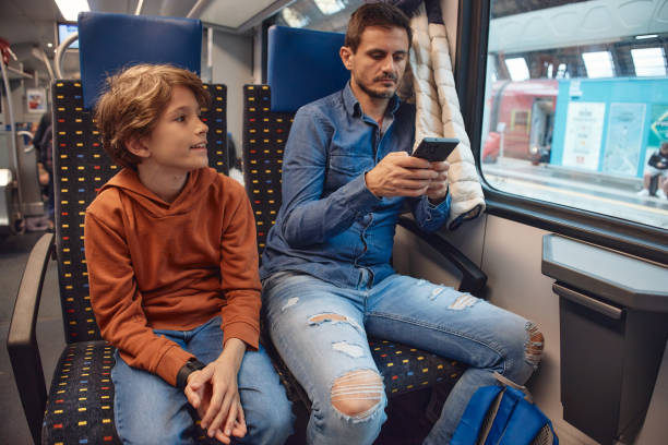 istock Father and son traveling by train 2193378091