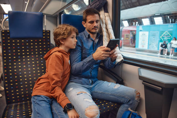 istock Father and son traveling by train 2193378098
