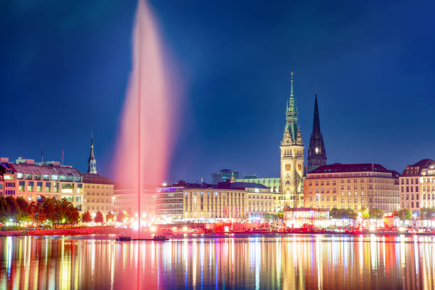 Panoramic view of Binnenalster (Inner Alster Lake) with Jungfernstieg and Rathaus in the background at night, Germany