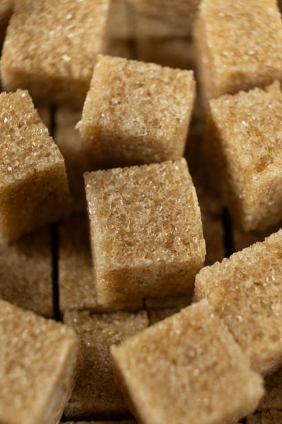 istock Macro cubes of brown cane unrefined demerara sugar. 2193380108