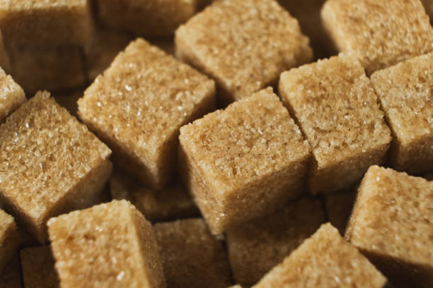 istock Macro cubes of brown cane unrefined demerara sugar. 2193380110