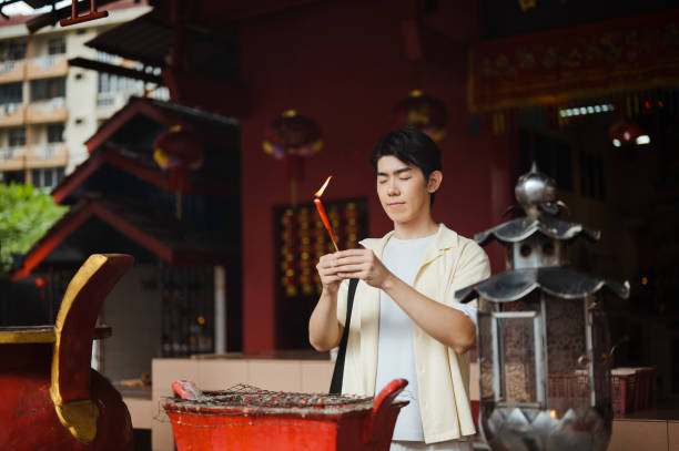 istock Asian tourist praying at temple 2193383974