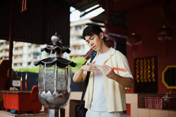 Asian tourist praying at temple