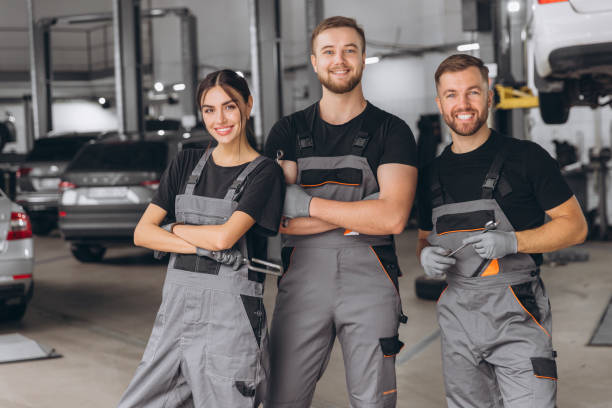 istock Group of three car service technician men and woman talking at workplace, people working together at vehicle repair garage service shop, check and repair customer car at automobile service center. 2193384762