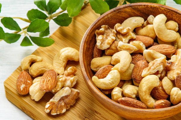 istock Assortment of nuts in wooden bowl 2193385446