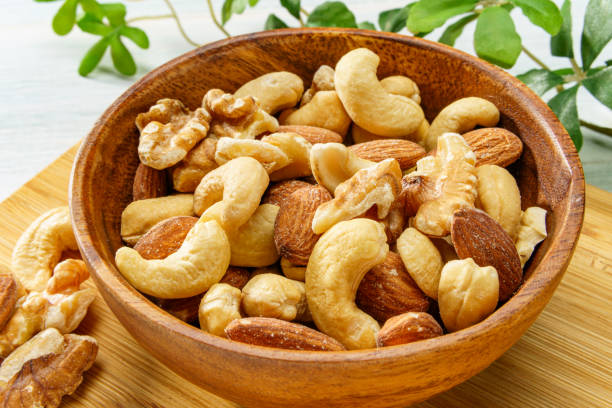 istock Assortment of nuts in wooden bowl 2193385461