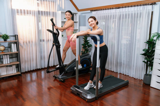istock Energetic and strong athletic asian woman running on machine. Vigorous 2193385926