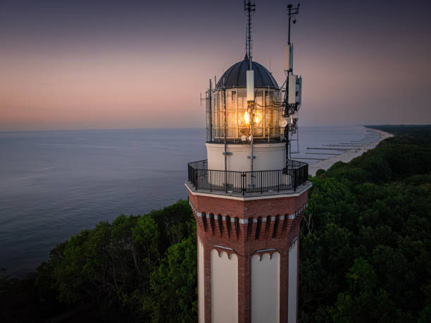 istock Lighthouse and light beam at Baltic Sea during sunset. 2193387383
