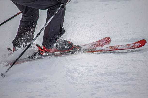 Two pairs of skis and ski boots close-up.