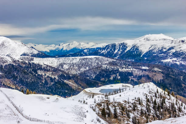 View of the snowy alpine landscape with glacier lake