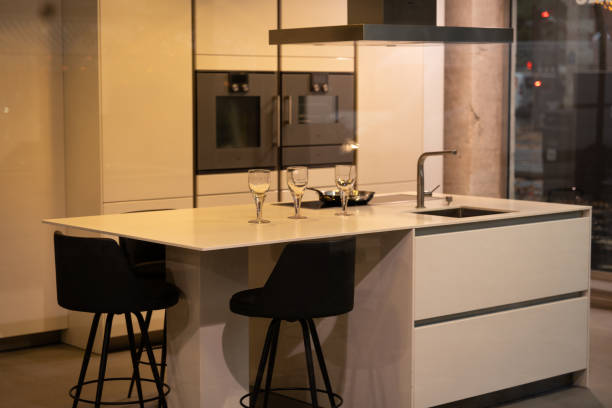 Modern kitchen design featuring a sleek countertop and stylish bar stools