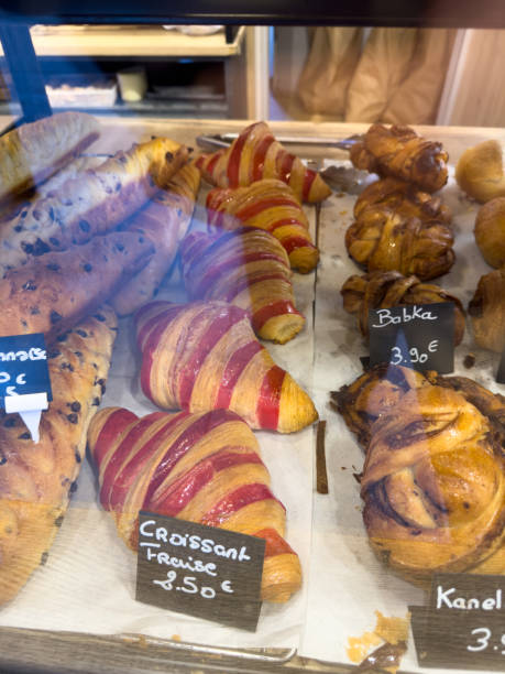 Delicious variety of freshly baked pastries displayed in a bakery case in early morning light