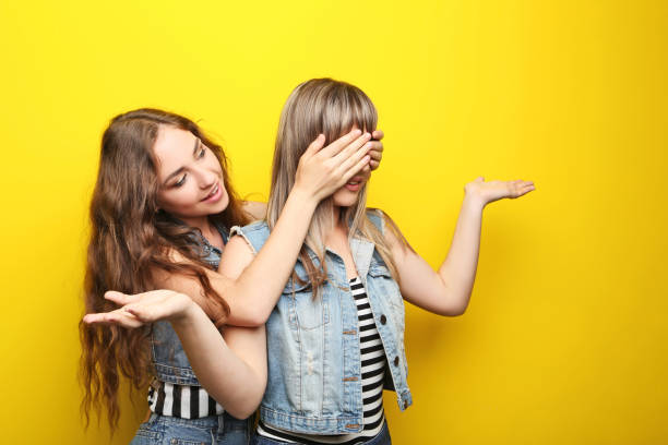 istock Two young woman on yellow background 2193391230