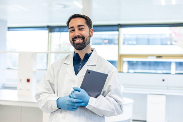 istock Scientist smiling and holding tablet in laboratory 2193391315