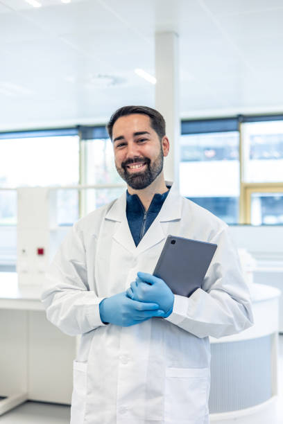 istock Scientist smiling and holding tablet in laboratory 2193391323