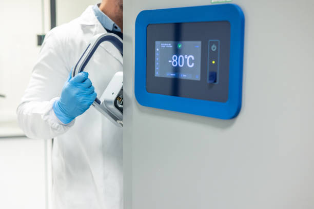 Scientist opening ultra-low temperature freezer in laboratory