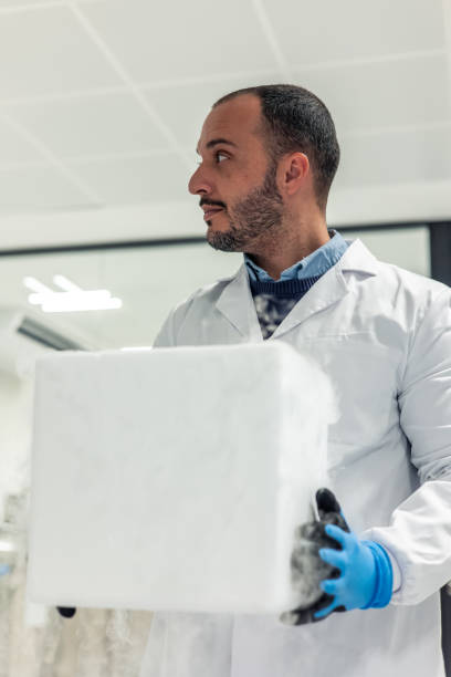 Scientist carrying a styrofoam box with dry ice in a laboratory