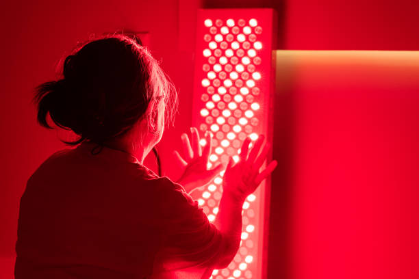 istock Back view of elderly woman during red light therapy session 2193392983