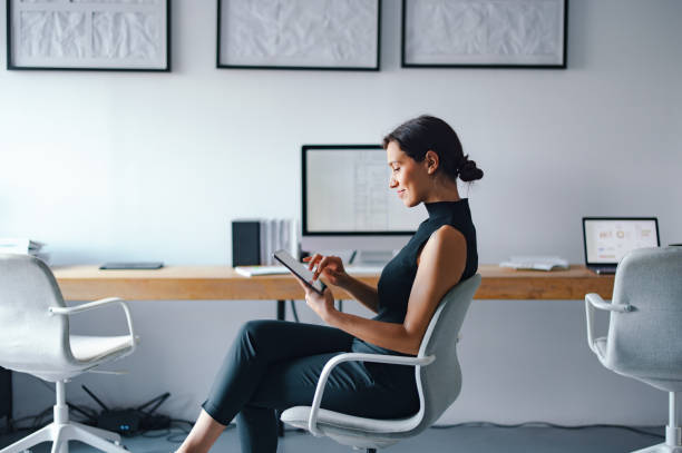 istock Professional Woman Working on Digital Tablet in Modern Office Setting 2193393868