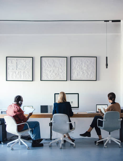 Coworkers Collaborating in a Modern Design Studio Office Environment