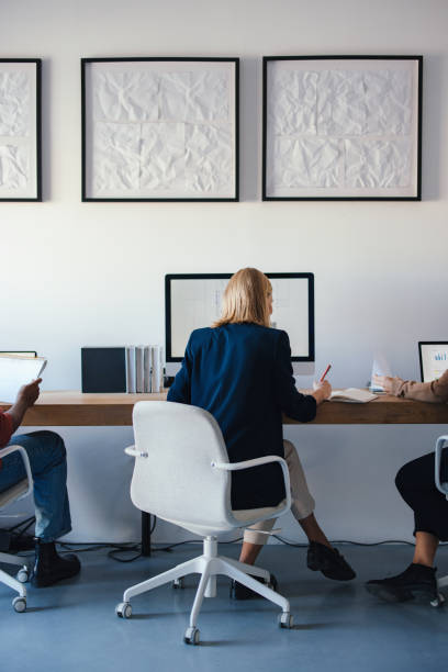 istock Young Coworkers Collaborating in a Modern Design Studio Workspace 2193393895