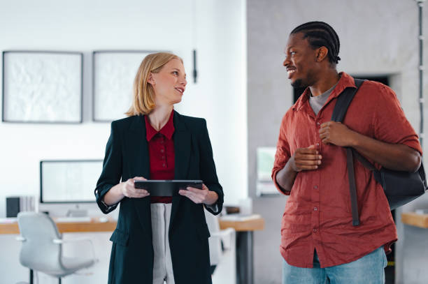 istock Young Coworkers Interacting in a Modern Office Environment 2193393910